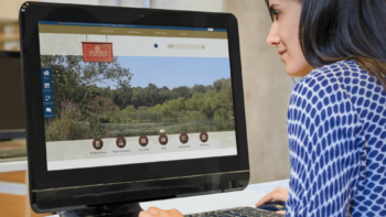 Woman looking at the Township of Morris website homepage on a computer