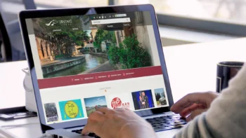 Laptop displaying the website homepage of Irving, Texas